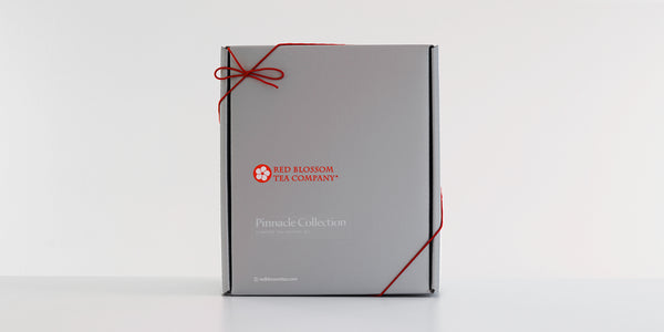 An unopened silver box with a label reading “Pinnacle Collection”