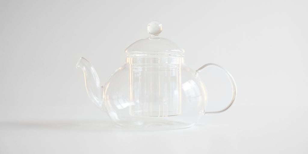 Side view of a glass teapot.