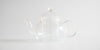 Side view of a glass teapot.