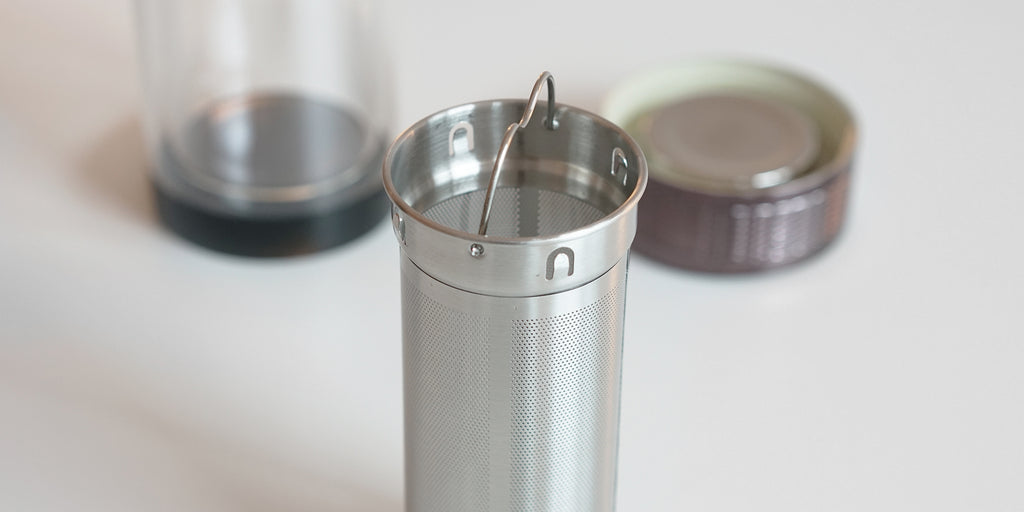 Close up of the strainer basket that fits into the thermos. There is a small wire handle at the top to remove it.