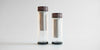 Two fully assembled thermoses side by side. The one on the left is larger, the one on the right is slightly shorter.