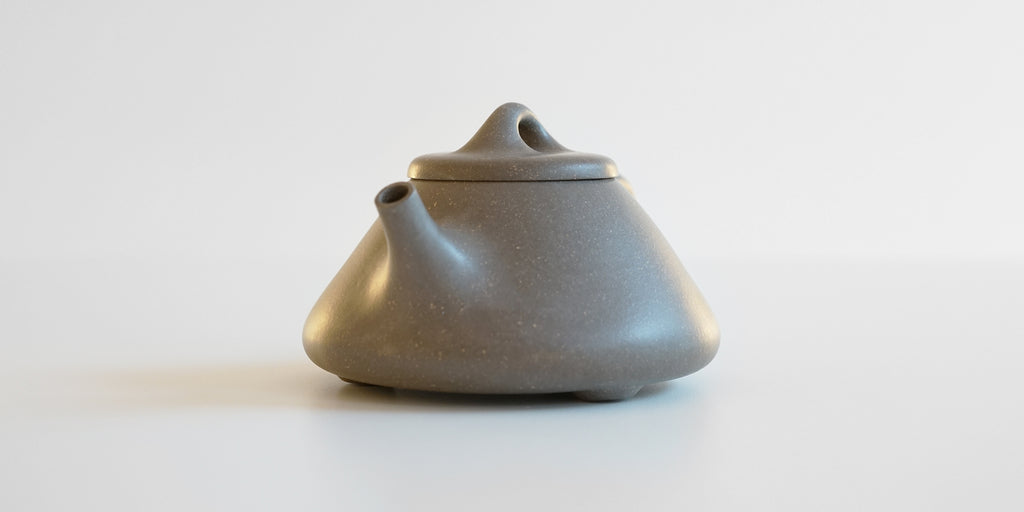 Front view of a gray duanni yixing teapot, highlighting the spout.