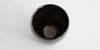 A top-down view of a jian-ware cup. Light shows the delicate hare's fur patterning on the inside.