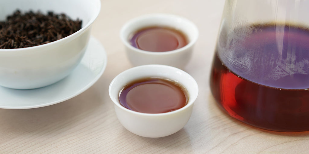 A top-down photo of brewed black tea leaves in a gaiwan.