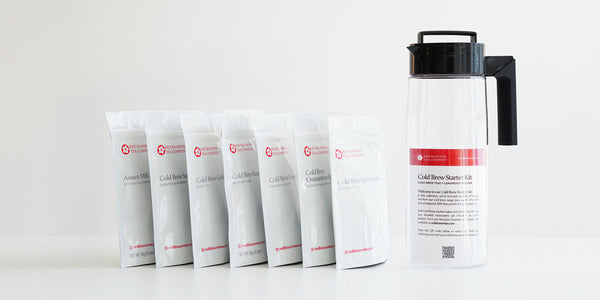 A set of 7 cold brew tea packages and a plastic pitcher on a white background