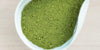 A white dish containing Formosa oolong matcha powder.