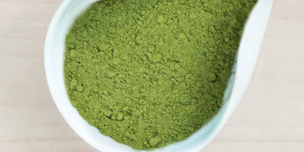A white dish containing Formosa oolong matcha powder.