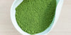 A white dish containing matcha powder.