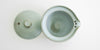 Top down view of the shiboridashi with the lid off to the side, showing the brown lip and the iron spot patterns inside.