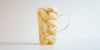 A glass cup filled with ice and Phoenix oolong tea on a white background.
