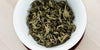 A top-down photo of brewed white tea leaves in a gaiwan.