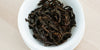 A top-down photo of brewed black tea leaves in a gaiwan.