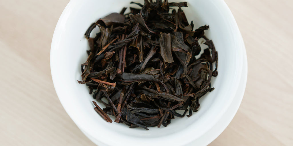 A top-down photo of brewed black tea leaves in a gaiwan.