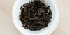 A top-down photo of brewed black tea leaves in a gaiwan.