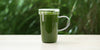 A glass cup full of brewed matcha