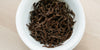 A top-down photo of brewed black tea leaves in a gaiwan.