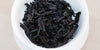 A top-down photo of brewed pu-erh tea leaves in a gaiwan.
