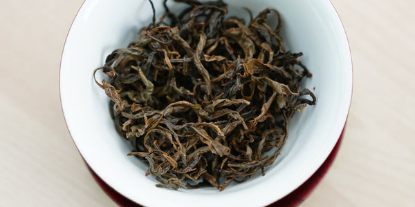 A top-down photo of brewed black tea leaves in a gaiwan.