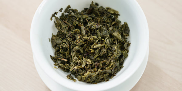 A top-down photo of brewed jasmine tea leaves in a gaiwan.