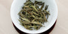 A top-down photo of brewed white tea leaves in a gaiwan.
