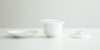 Side view of all the pieces for the gaiwan. From left to right, the plate, the bowl, and the lid