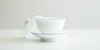 Side view of the gaiwan, with the lid off kilter resting on its side against the bowl.