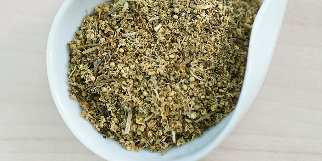 A white dish containing dry elderflower.