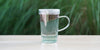 A glass cup with lavender brewing in the nested glass infuser.