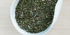 A white dish containing dry peppermint leaves and lavender flowers.