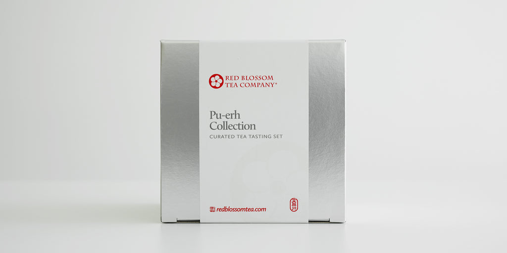 A silver box with a white label reading “Pu-erh Collection”