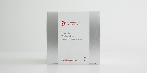 A silver box with a white label reading “Pu-erh Collection”