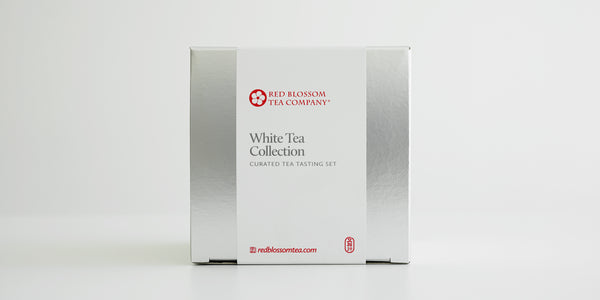 A silver box with a white label reading “White Tea Collection”