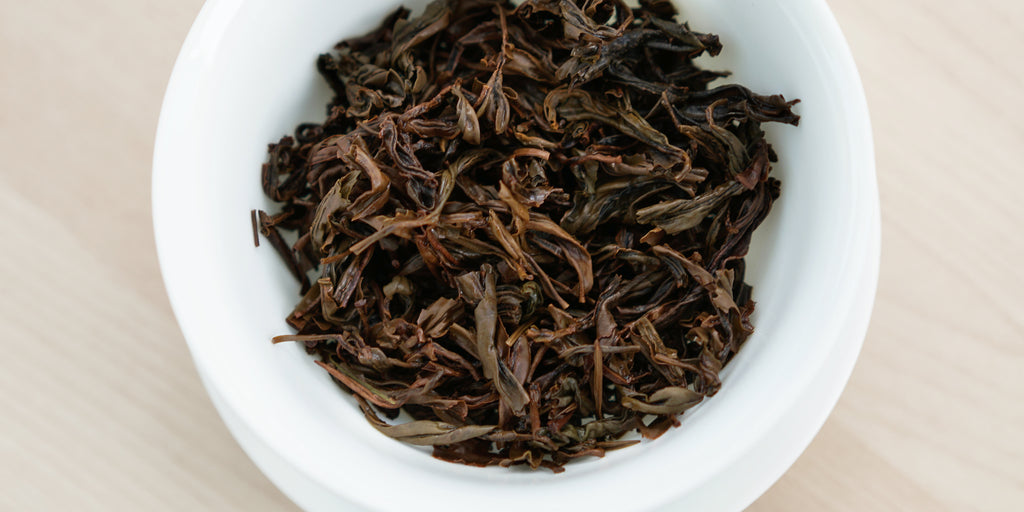 A top-down photo of brewed black tea leaves in a gaiwan.